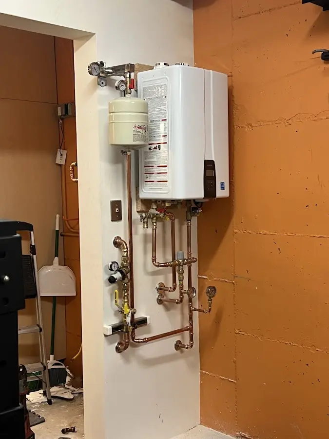 Plumbing technician inspecting water heater connections in Merritt Island